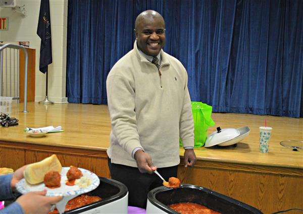 Principal Alston serves up his homemade meatballs. 